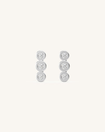 A Vertical Trio Of Delight Diamond Studs