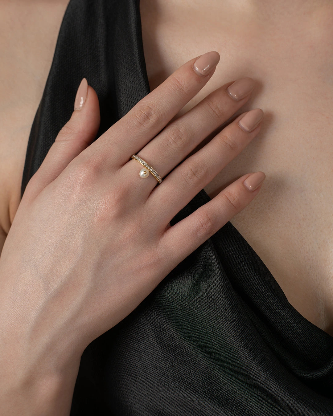 Pearl ring in middle finger