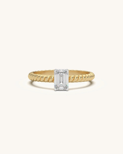 Elegant emerald cut moissanite solitaire ring in 18K gold vermeil sterling silver with a slender twist band.