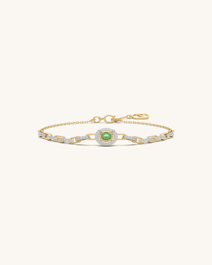 Emerald bracelet with green center stone and pavé halo design