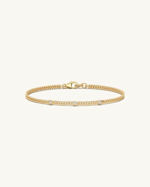Dainty bracelets with three bezel set round diamonds on slim chain