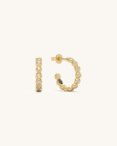 Modern vertical bezel stud earrings in 18KT gold vermeil with multiple moissanite diamonds, arranged linearly on a white background