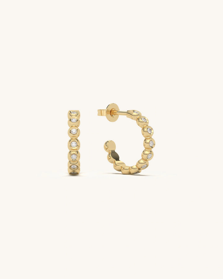 Modern vertical bezel stud earrings in 18KT gold vermeil with multiple moissanite diamonds, arranged linearly on a white background