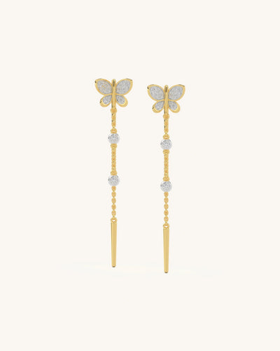 Gold vermeil butterfly chain drop earrings with delicate moissanite stones on a long vertical chain.