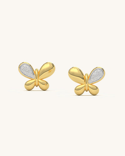 Pair of two tone butterfly stud earrings featuring 18K gold vermeil lower wings and moissanite diamond upper wings on a white background.
