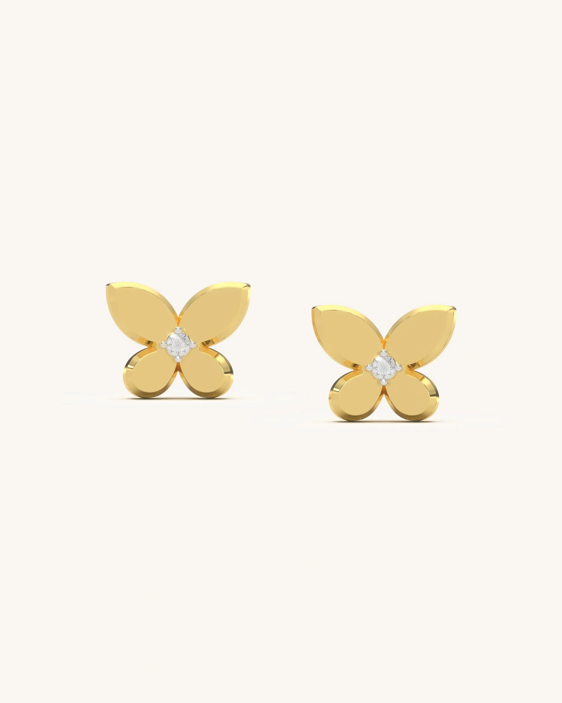 Pair of classic butterfly stud earrings with a central moissanite stone and polished 18K gold vermeil wings on a clean background.