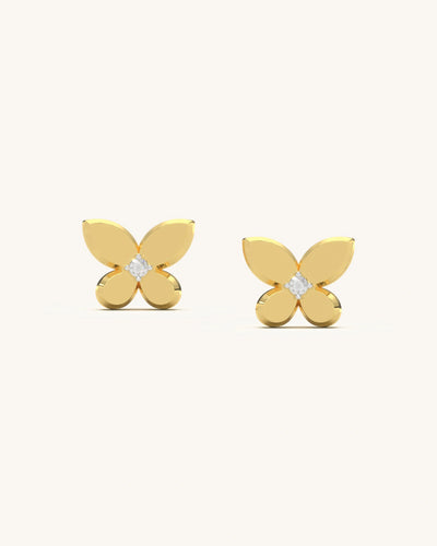 Pair of classic butterfly stud earrings with a central moissanite stone and polished 18K gold vermeil wings on a clean background.
