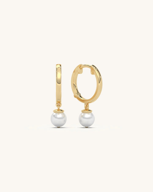 Model wearing 18K gold vermeil 925 sterling silver hoop pearl earrings with suspended round pearl drop from SHAYN jewelry