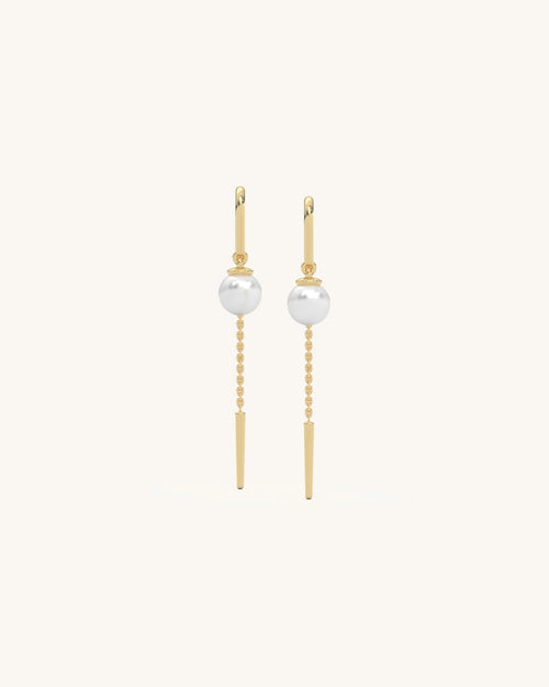 Model wearing dainty 18K gold vermeil 925 sterling silver pearl chain earrings with floating pearl drop from SHAYN
