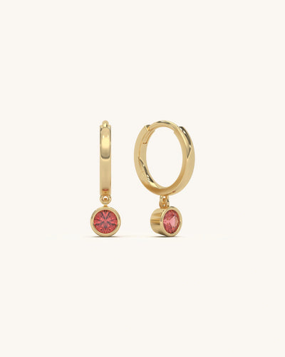 Ruby Drop Hoops crafted from 18KT Gold Vermeil over 925 Sterling Silver, featuring a vibrant ruby-colored charm.