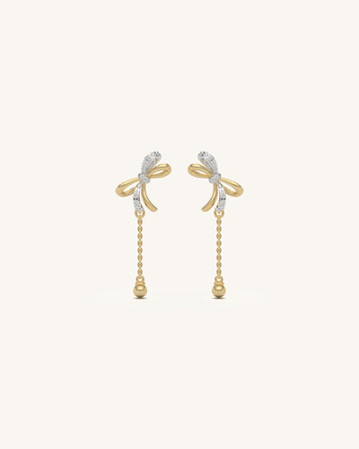 Pair of delicate mini ribbon studs in 18KT gold vermeil with moissanite, shown on a white background.