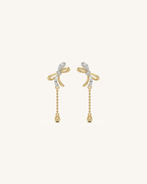 Pair of delicate mini ribbon studs in 18KT gold vermeil with moissanite, shown on a white background.