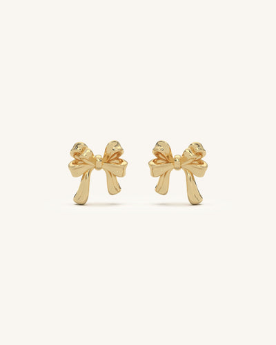 Elegant dangling bow earrings in 18KT gold vermeil, featuring triple chain drops with small golden beads.