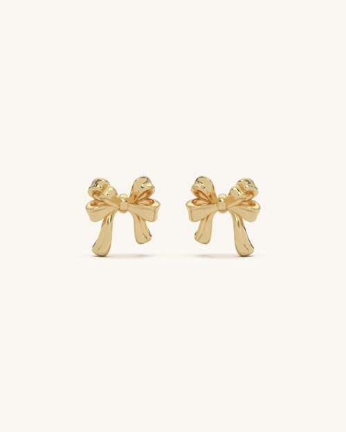 Elegant dangling bow earrings in 18KT gold vermeil, featuring triple chain drops with small golden beads.