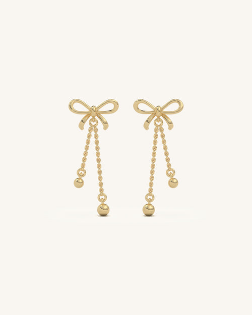 Elegant long bow drop earrings featuring 18KT gold vermeil, 925 sterling silver, and sparkling moissanite diamonds, perfect for a sophisticated look.