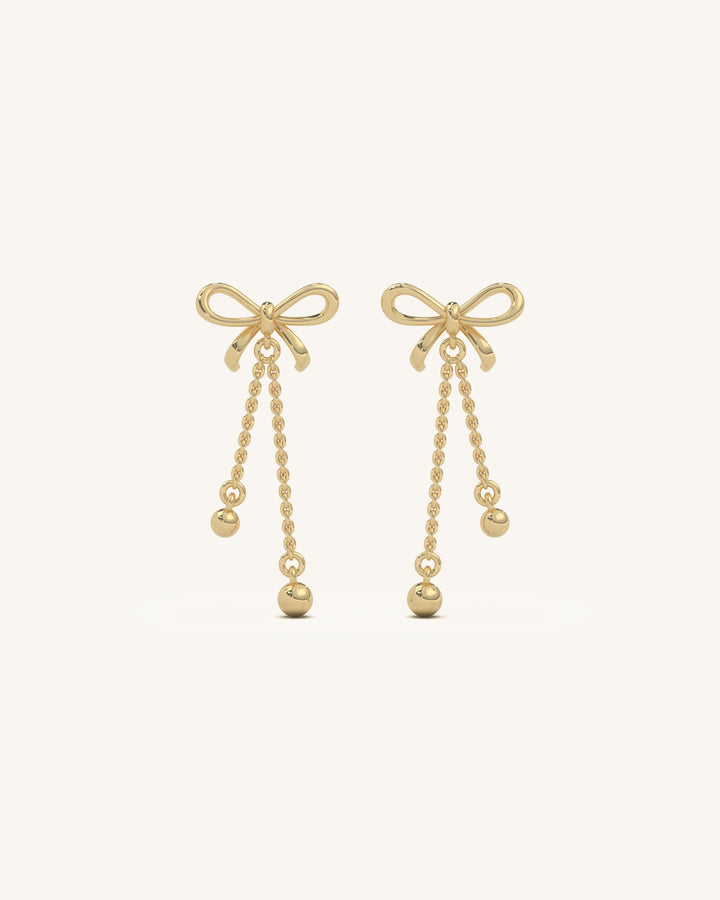 Elegant long bow drop earrings featuring 18KT gold vermeil, 925 sterling silver, and sparkling moissanite diamonds, perfect for a sophisticated look.