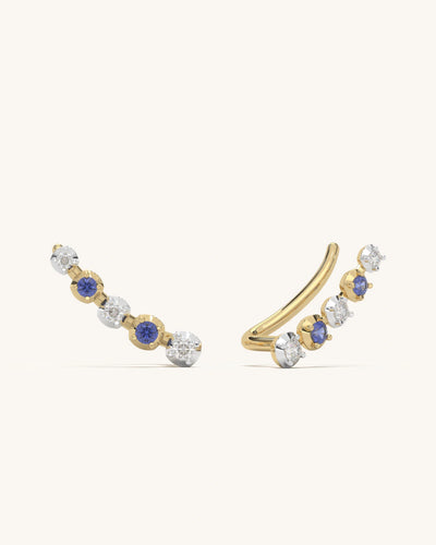 Pair of blue and white climber earrings crafted in 18K gold vermeil silver with moissanite and blue stones.