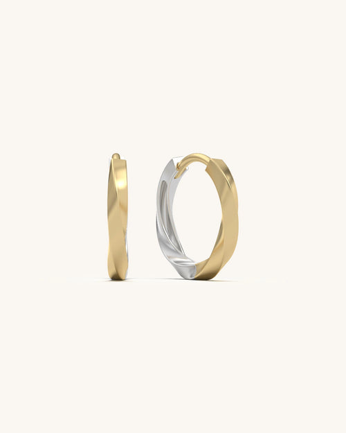Close-up of SHAYN Twist Huggie Earrings in 18KT Gold Vermeil, highlighting their soft spiral form and dual-tone metalwork.