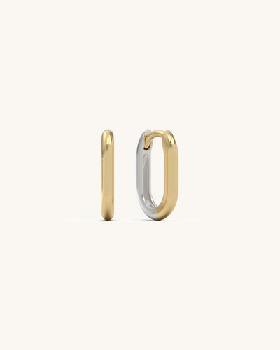 Close-up of gold vermeil satin U huggie earrings with a smooth, polished finish, reflecting light softly.