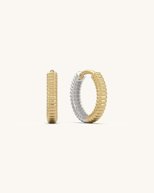 Close-up of Grooved Curve Huggies earrings in 18K Gold Vermeil and 925 Sterling Silver, highlighting their distinctive rippled texture