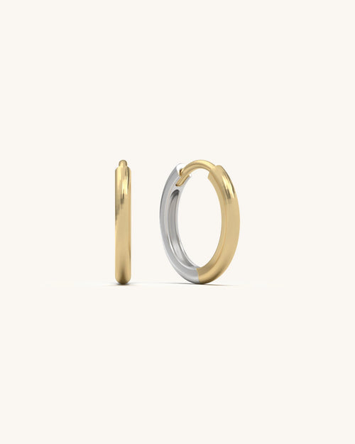 Shiny pair of Smooth Hoop Huggies earrings in 18K Gold Vermeil and 925 Sterling Silver, showing their sleek, polished surface