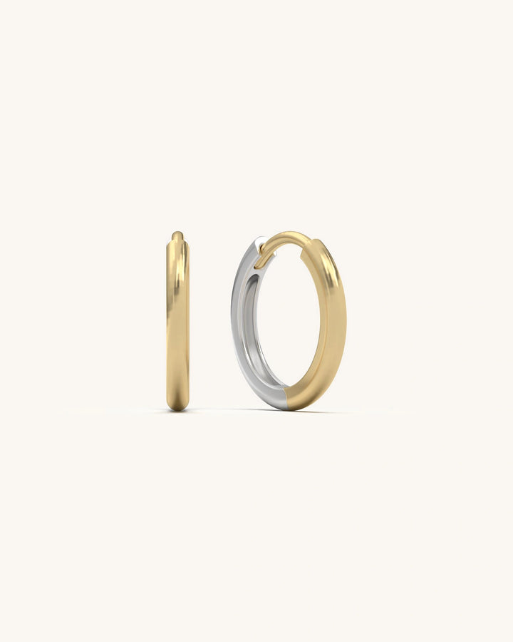 Shiny pair of Smooth Hoop Huggies earrings in 18K Gold Vermeil and 925 Sterling Silver, showing their sleek, polished surface