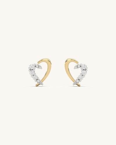 Close-up of SHAYN Curved Heart Studs in 18K Gold Vermeil with Moissanite stones on 925 Sterling Silver